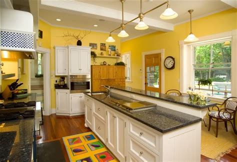 steel appliances black countertop white cabinets and yellow walls kitchen|black and white kitchen appliances.